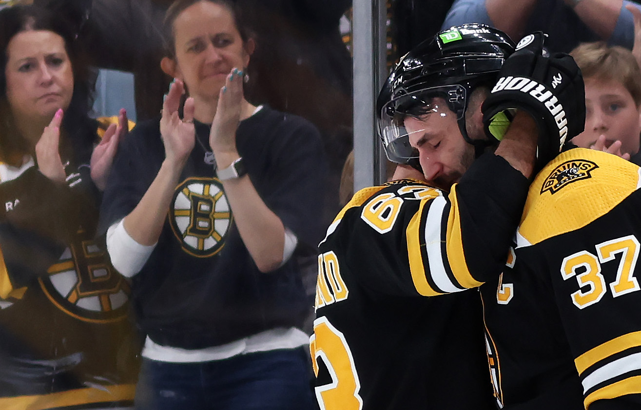 BOSTON, MASSACHUSETTS - APRIL 30: Patrice Bergeron #37 of the Boston Bruins hugs Brad Marchand #63 before exiting the ice after Florida Panthers defeat the Bruins 4-3 in overtime of Game Seven of the First Round of the 2023 Stanley Cup Playoffs at TD Garden on April 30, 2023 in Boston, Massachusetts. (Photo by Maddie Meyer/Getty Images)