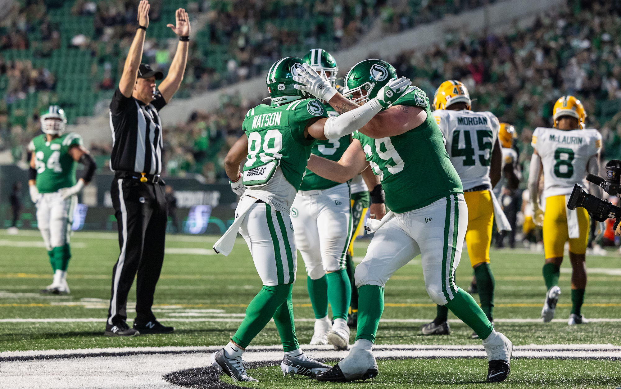 REGINA, CANADA - JULY 6: Kendall Watson #88 and Logan Bandy #69 of the Saskatchewan Roughriders celebrate after a two point conversion that tied the game between the Edmonton Elks and Saskatchewan Roughriders at Mosaic Stadium on July 6, 2023 in Regina, Canada. (Photo by Brent Just/Getty Images)
