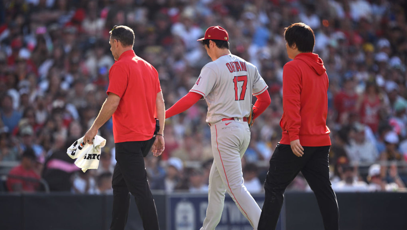 SAN DIEGO, CALIFORNIA - JULY 04: Shohei Ohtani #17 of the Los Angeles Angels walks to the dugout after being replaced during the sixth inning against the San Diego Padres at PETCO Park on July 04, 2023 in San Diego, California.