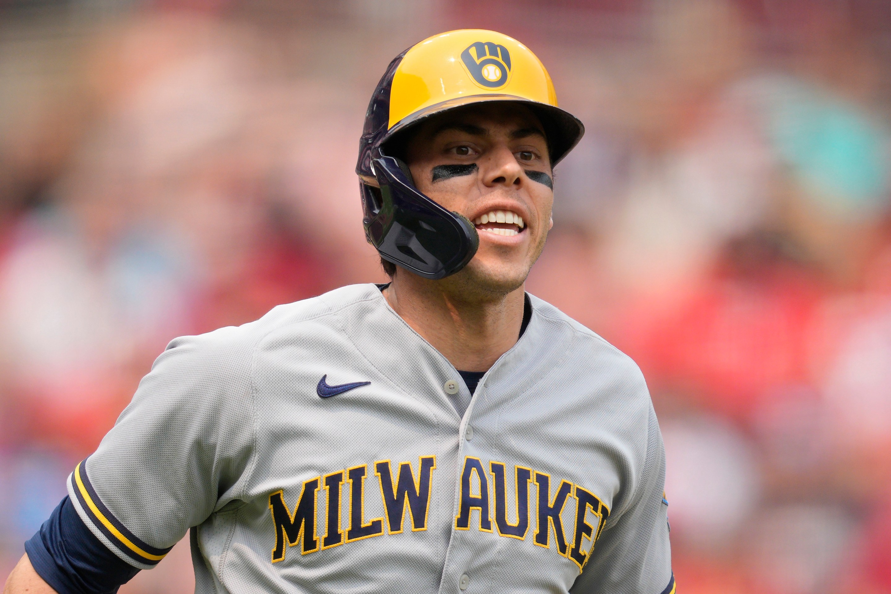 Christian Yelich #22 of the Milwaukee Brewers reacts after drawing a walk during the seventh inning of a baseball game against the Cincinnati Reds at Great American Ball Park on July 16, 2023 in Cincinnati, Ohio.