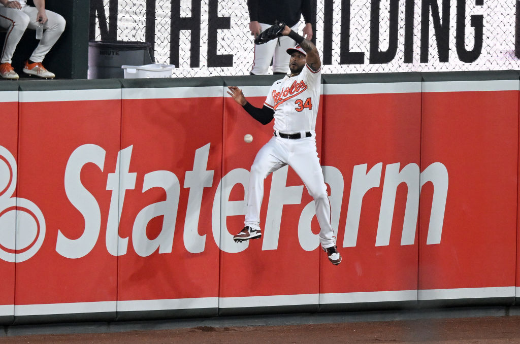 Aaron Hicks tries to catch a triple by Freddie Freeman