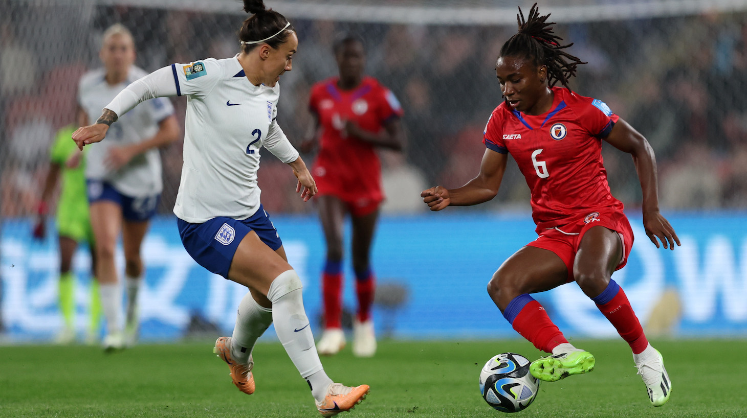 Lucy Bronze of England battles for possession with Melchie Dumornay of Haiti during the FIFA Women's World Cup Australia & New Zealand 2023 Group D match between England and Haiti at Brisbane Stadium on July 22, 2023 in Brisbane / Meaanjin, Australia.