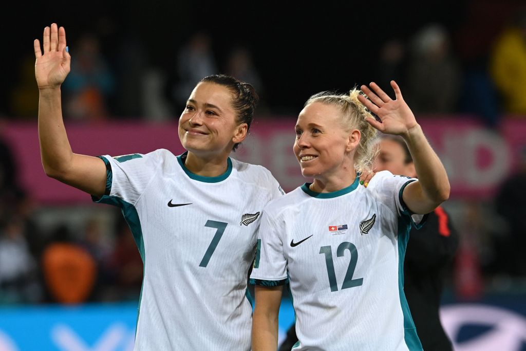 New Zealand's defender #07 Ali Riley (L) and New Zealand's midfielder #12 Betsy Hassett (R) greet supporters at the end of Australia and New Zealand 2023 Women's World Cup Group A football match between Switzerland and New Zealand at Dunedin Stadium in Dunedin on July 30, 2023.