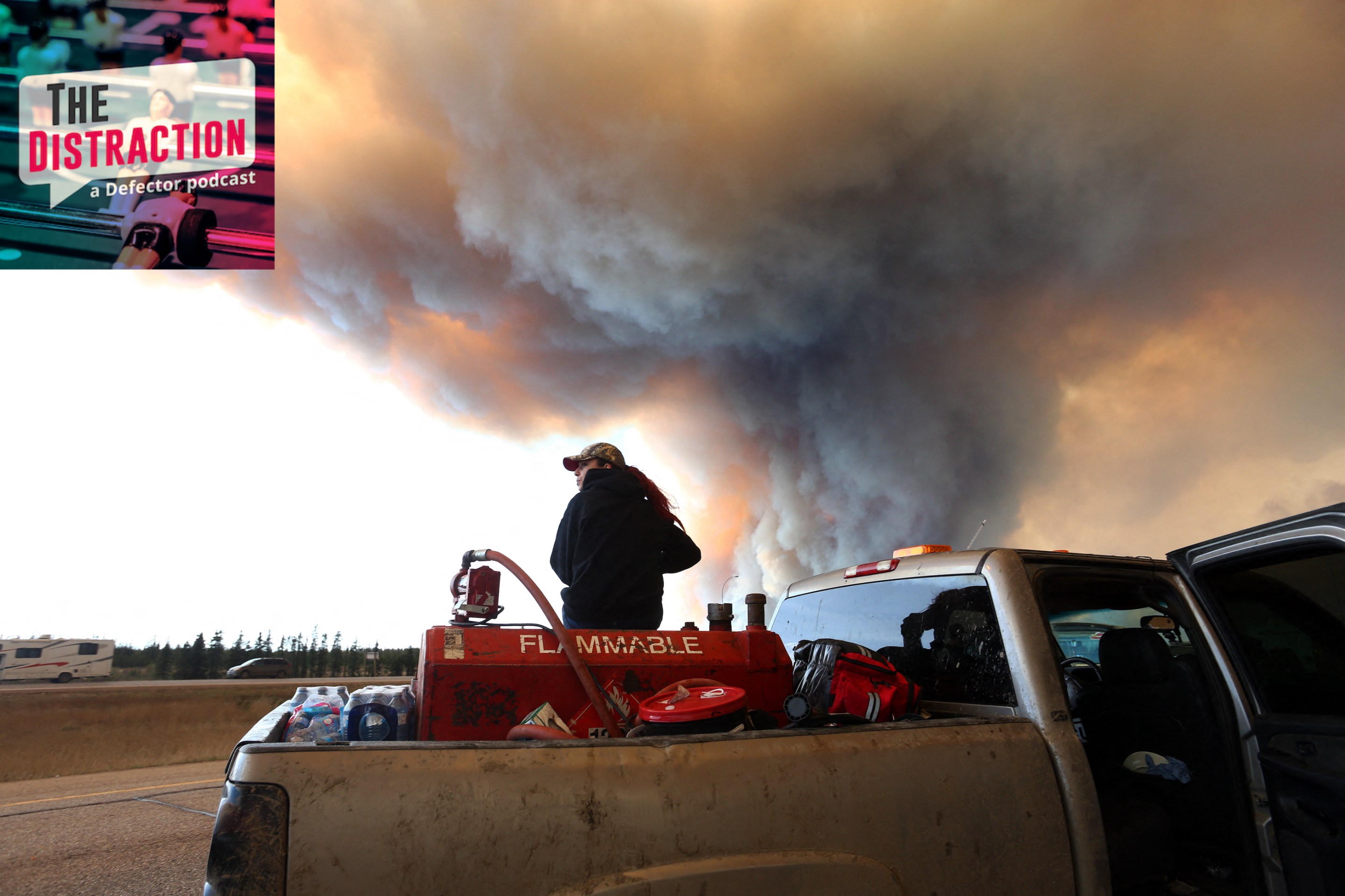 A group trying to rescue animals from the massive forest fire around Fort McMurray in Alberta wait at a roadblock on May 6, 2016. The Distraction logo is at top left.