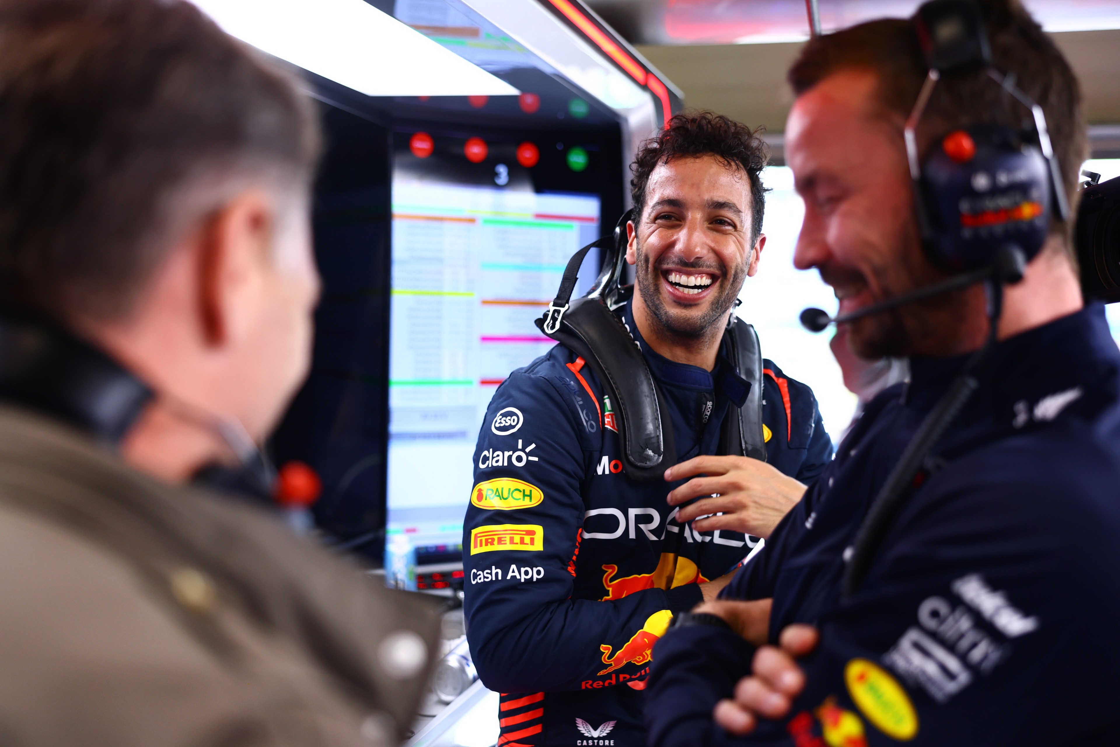 Daniel Ricciardo smiles in his Red Bull uniform.
