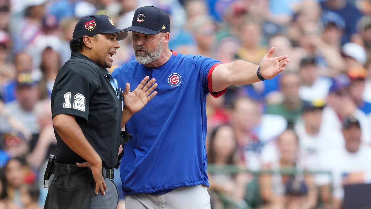 MILWAUKEE, WISCONSIN - JULY 04: Manager David Ross #3 of the Chicago Cubs argues with home plate umpire Erich Baccus #12 after a call in the sixth inning against the Milwaukee Brewers at American Family Field on July 04, 2023 in Milwaukee, Wisconsin.