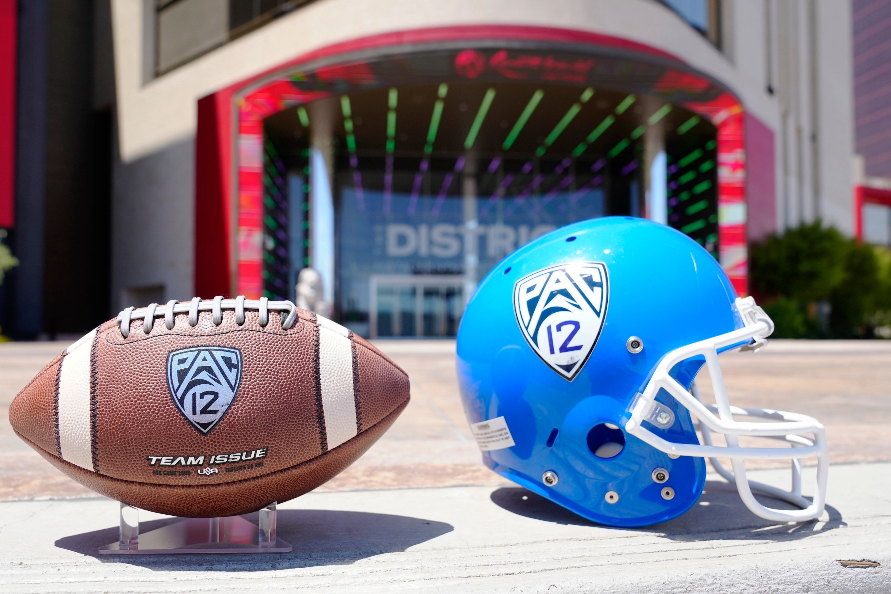 A football and helmet set up outside the Pac-12's media days in Las Vegas, which were held just a few weeks before the conference ceased to exist.