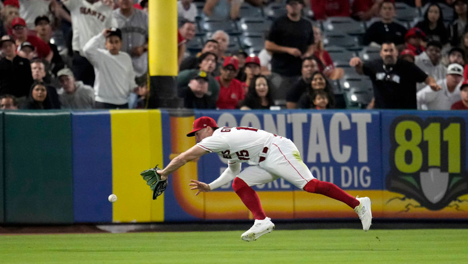 Randal Grichuk #15 of the Los Angeles Angels fails to deny a two-run double by Patrick Bailey #14 of the San Francisco Giants during the ninth inning at Angel Stadium of Anaheim on August 7, 2023 in Anaheim, California.
