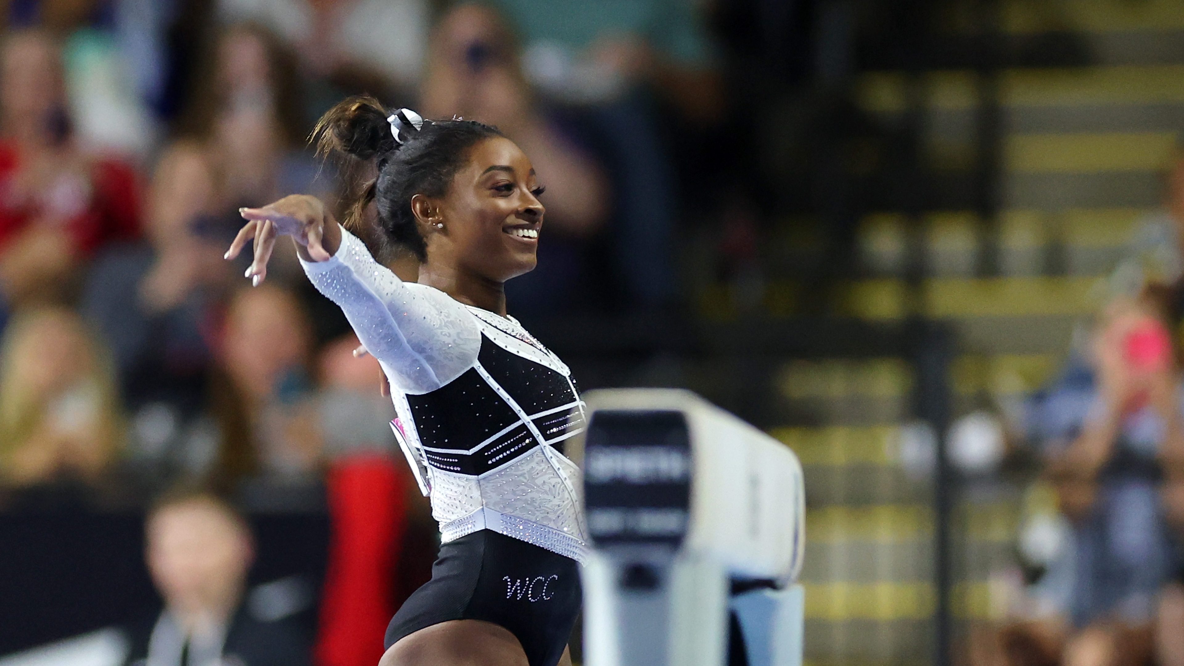 Simone Biles smiling after she competes on the balance beam during the Core Hydration Classic at Now Arena on August 05, 2023 in Hoffman Estates, Illinois.
