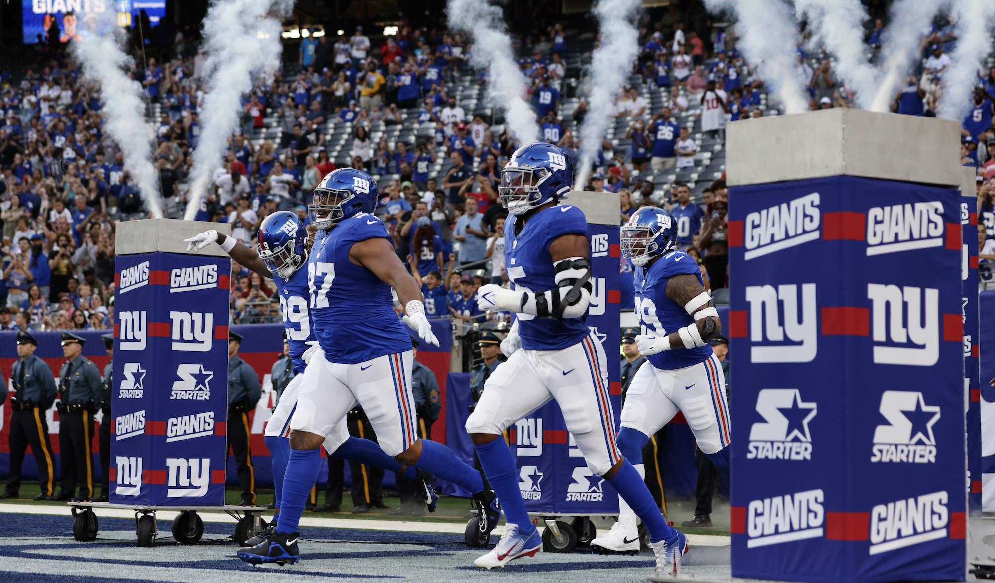 EAST RUTHERFORD, NEW JERSEY - AUGUST 18: Xavier McKinney #29, Dexter Lawrence II #97 and Kayvon Thibodeaux #5 of the New York Giants run out onto the field before a pre-season football game against the Carolina Panthers at MetLife Stadium on August 18, 2023 in East Rutherford, New Jersey. The Giants defeated the Panthers 21-19. (Photo by Rich Schultz/Getty Images)