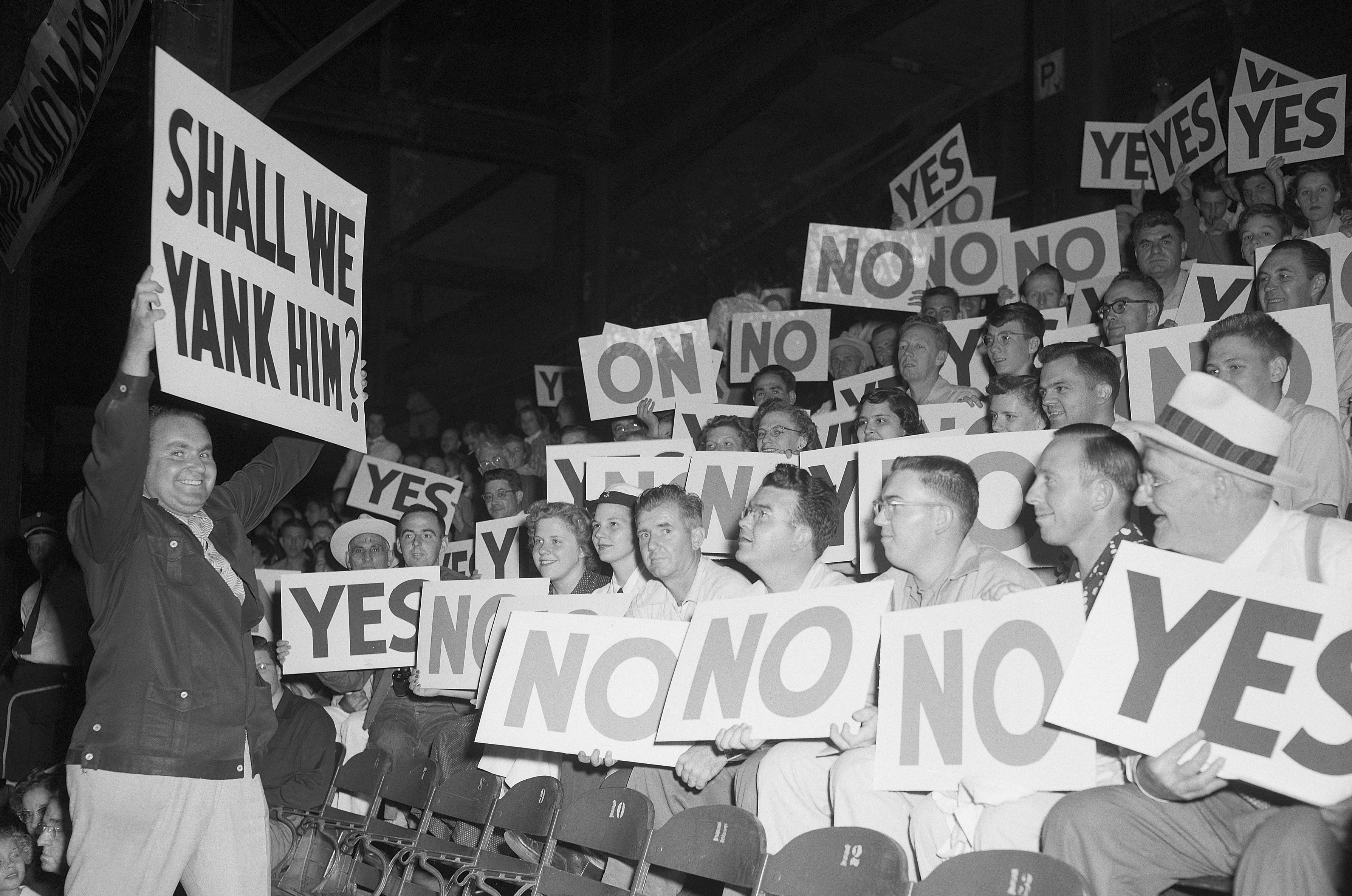 (Original Caption) 8/27/1951-St. Louis, MO-: Bill Veeck, new owner of the St. Louis Browns, who believes that a zany atmosphere in baseball is good "box office," carried his idea to a new high when he staged a "grandstand managers" night when the Brownies played the Philadelphia Athletics. Fans who always know what the managers of the opposing teams "shouldda done" were given the opportunity to vote on decisions. Here, Jay Edson, of the Browns publicity staff, is asking the Board of Managers to decide on a pitcher.
