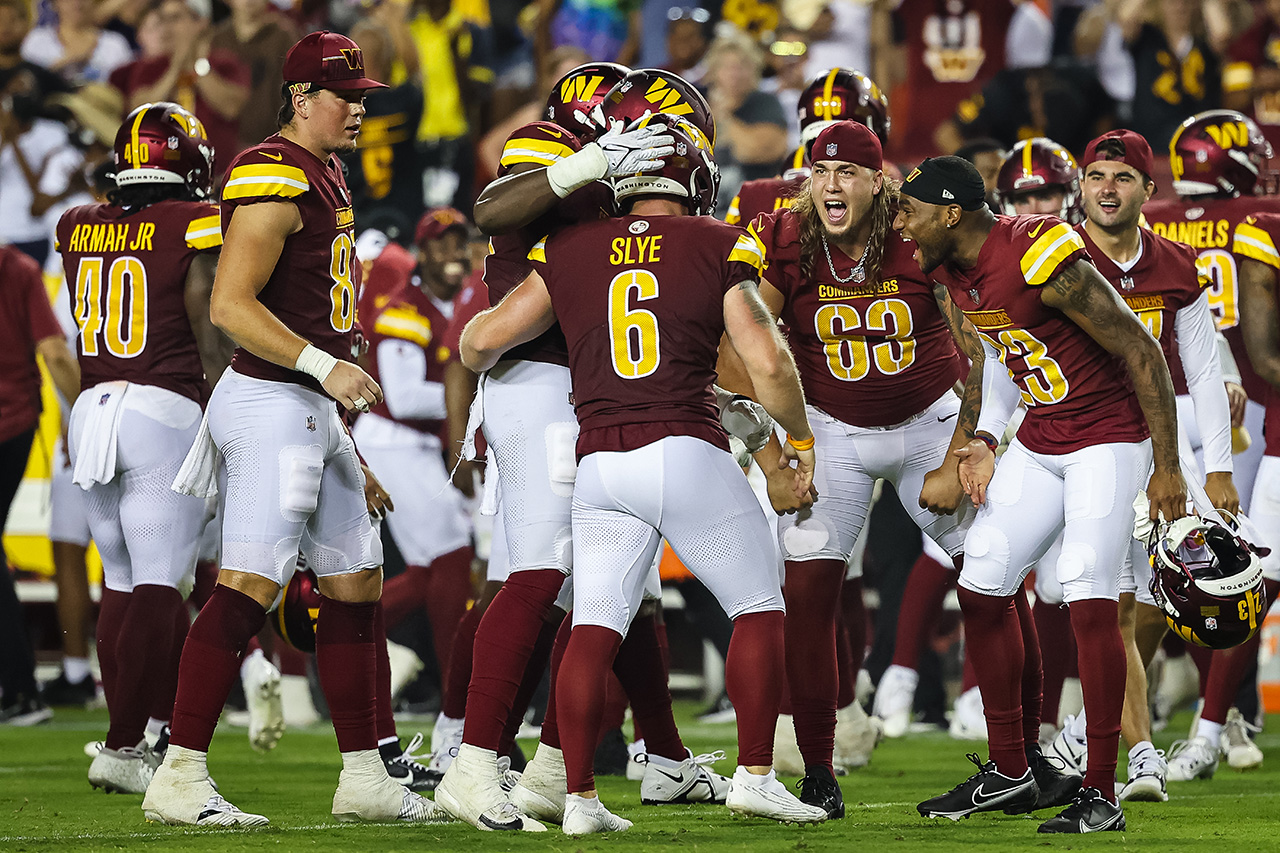 LANDOVER, MD - AUGUST 21: Joey Slye #6 of the Washington Commanders celebrates with teammates after kicking the go-ahead field goal against the Baltimore Ravens during the second half of the preseason game at FedExField on August 21, 2023 in Landover, Maryland.