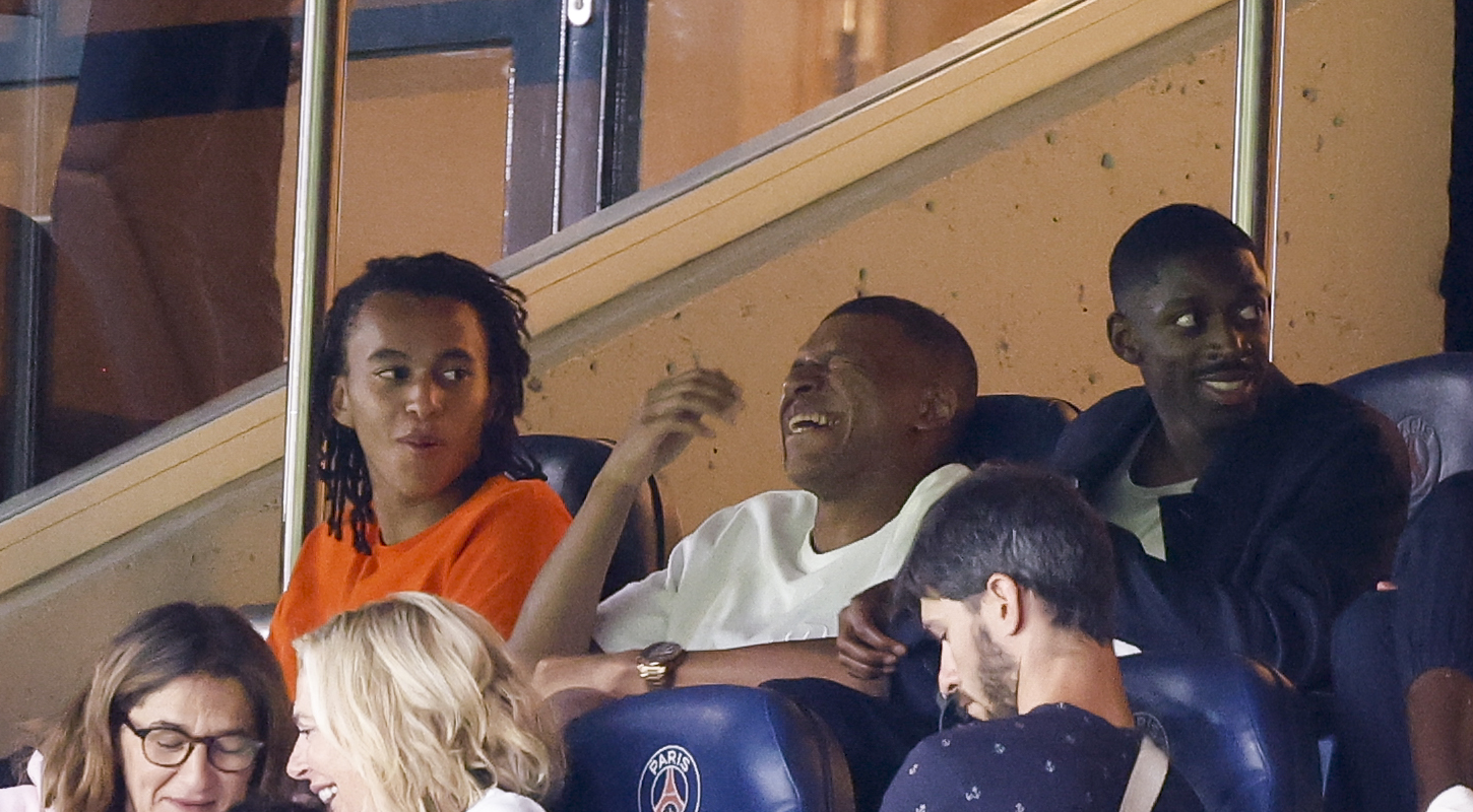 Kylian Mbappé laughs while watching PSG from a skybox