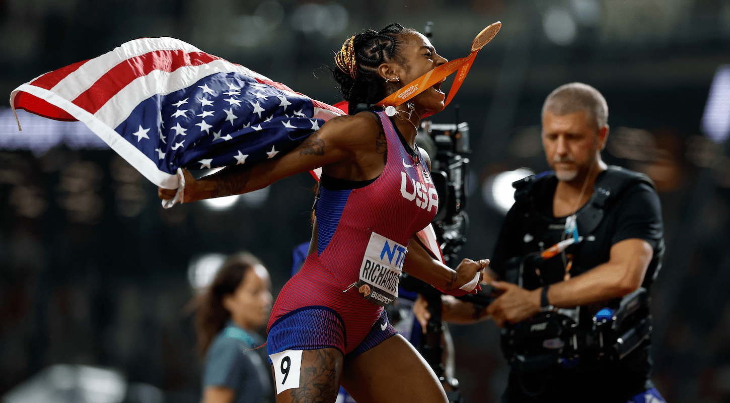 Sha'Carri Richardson celebrates her 100-meter final win at the 2023 track and field world championships.