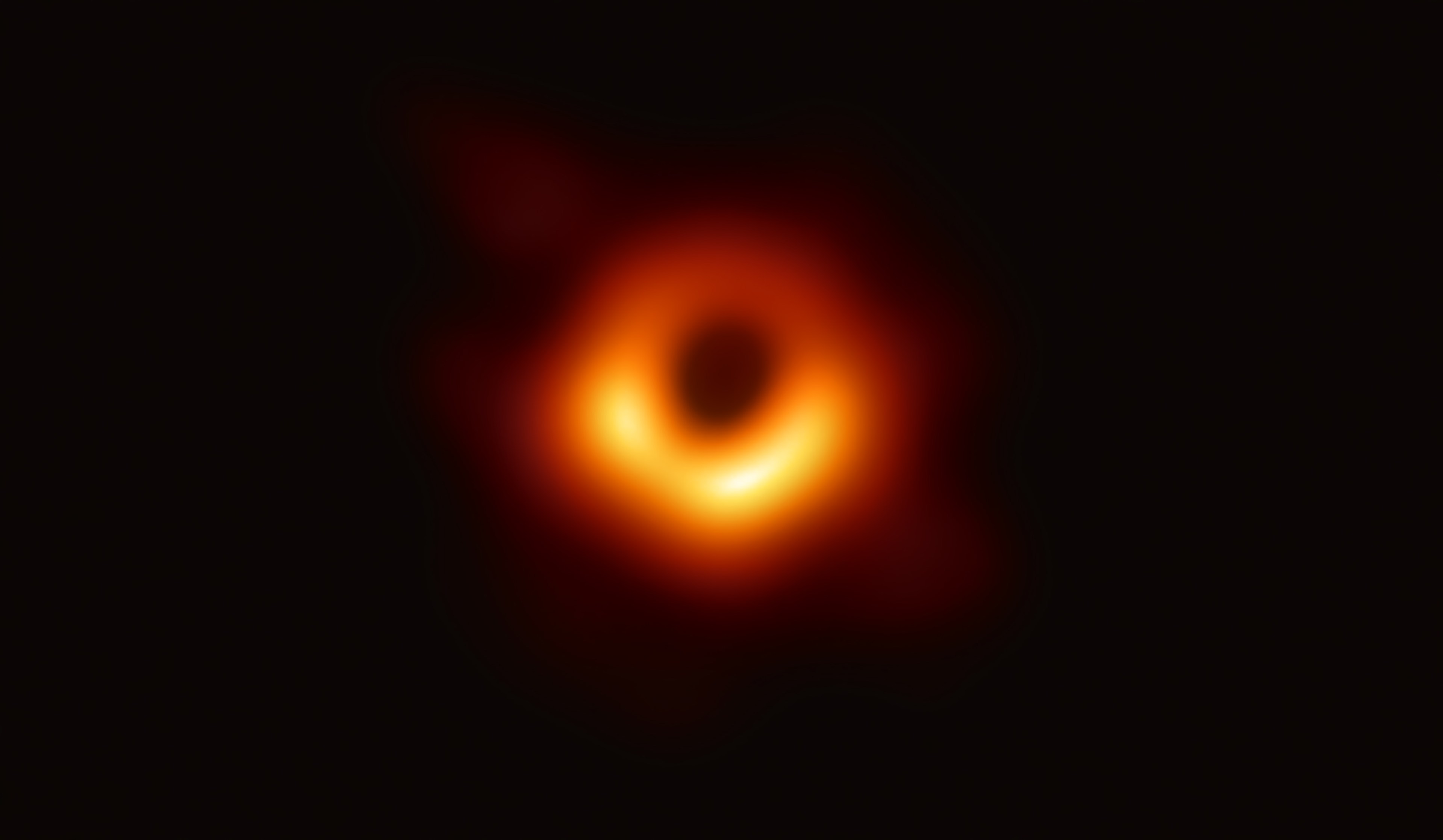 IN SPACE - APRIL 10: In this handout photo provided by the National Science Foundation, the Event Horizon Telescope captures a black hole at the center of galaxy M87, outlined by emission from hot gas swirling around it under the influence of strong gravity near its event horizon, in an image released on April 10, 2019. A network of eight radio observatories on six mountains and four continents, the EHT observed a black hole in Messier 87, a supergiant elliptical galaxy in the constellation Virgo, on and off for 10 days in April of 2017 to make the image. (Photo by National Science Foundation via Getty Images)