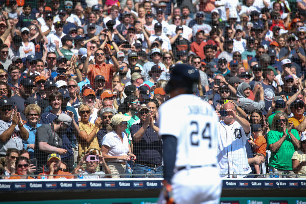 Fans stand and cheer as Miguel Cabrera walks to the dugout