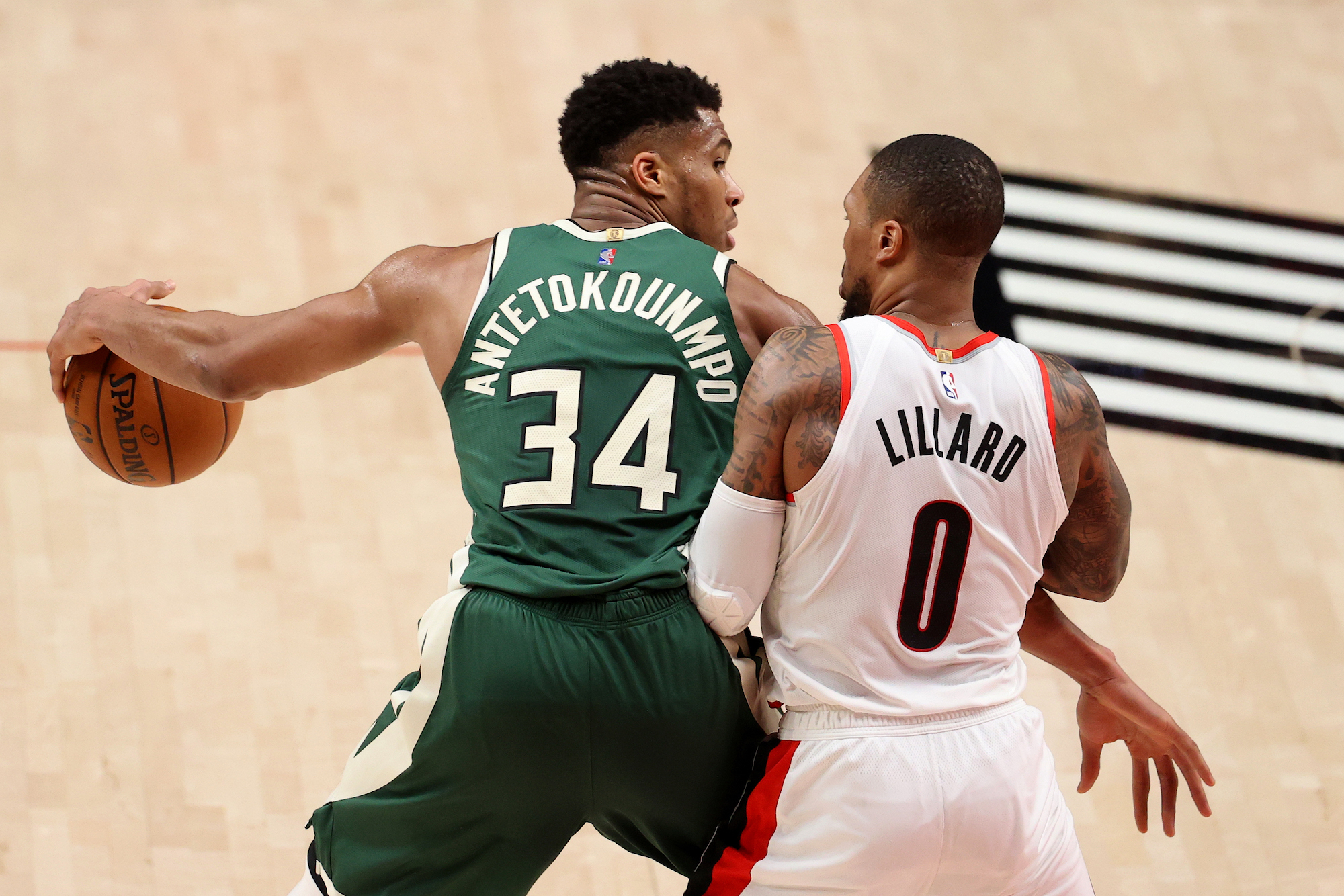 Giannis Antetokounmpo and Damian Lillard in a game between the Bucks and Blazers