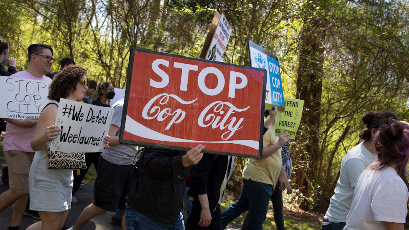 Environmental activists hold a rally and a march through the Atlanta Forest, a preserved forest Atlanta that is scheduled to be developed as a police training center, March 4, 2023 in Atlanta, Georgia. Intent upon stopping the building of what they have called cop city, the environmentalists were evicted from the forest in January, resulting in the killing by police of Manuel Teran, a young activist and medic.
