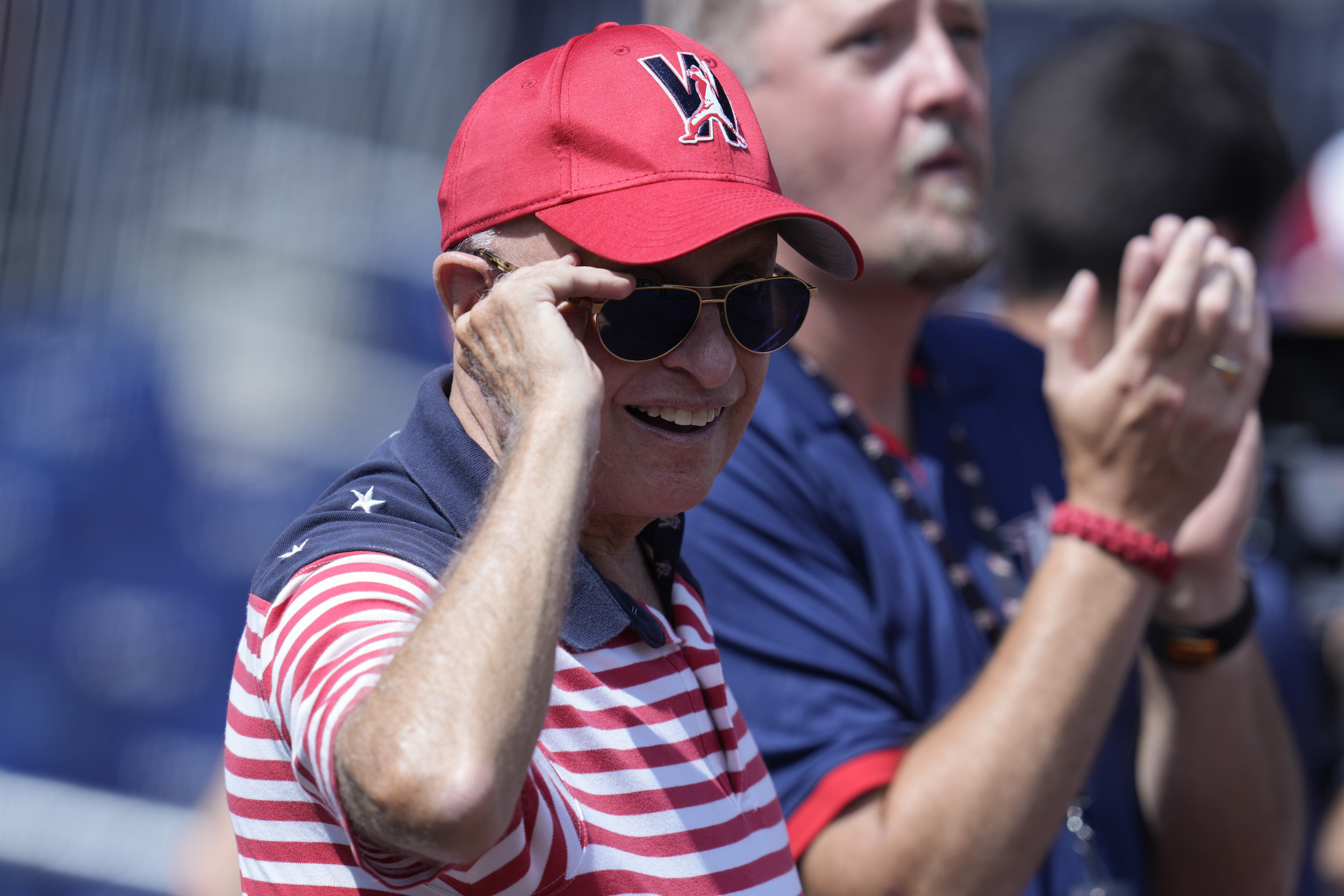 Nationals owner Mark Lerner smiles in sunglasses at a Nationals game.
