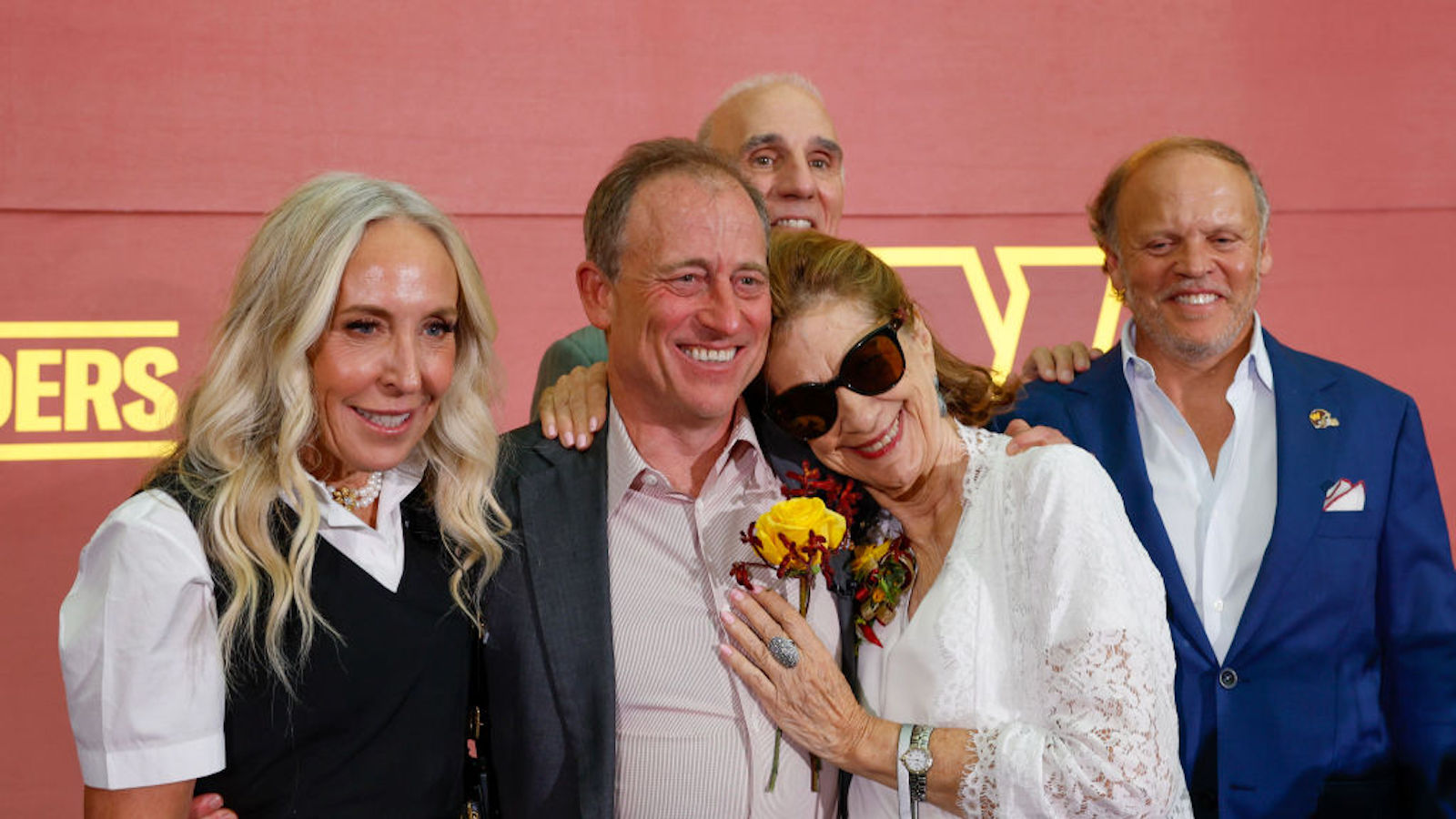 Josh Harris (C), a new owner of the Washington Commanders, poses for a photo with his wife Marjorie Harris (L) and mother Sylvia Harris after a press conference introducing the team's new ownership at FedExField on July 21, 2023 in Landover, Maryland. NFL teams owners have unanimously approved a $6.05 billion sale of the Commanders from Dan Snyder to a group led by Josh Harris.