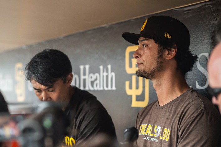 Yu Darvish sits in the dugout, looking grim.