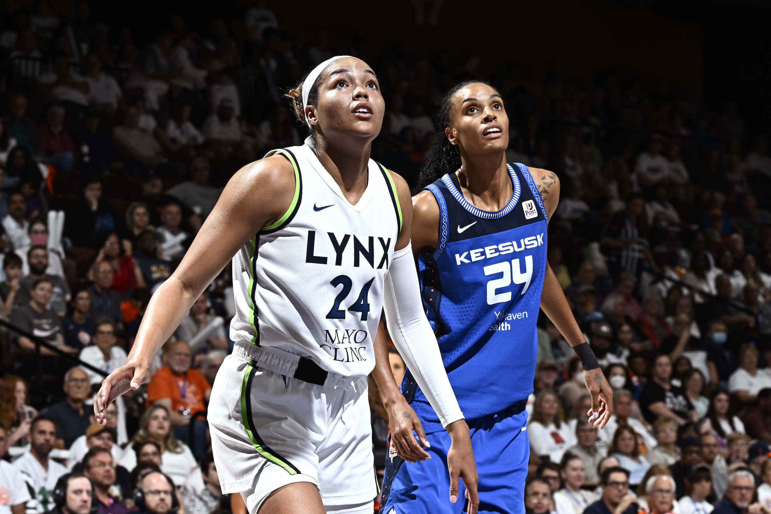 Napheesa Collier #24 of the Minnesota Lynx and DeWanna Bonner #24 of the Connecticut Sun looks on during the game on September 17, 2023 at the Mohegan Sun Arena in Uncasville, Connecticut.