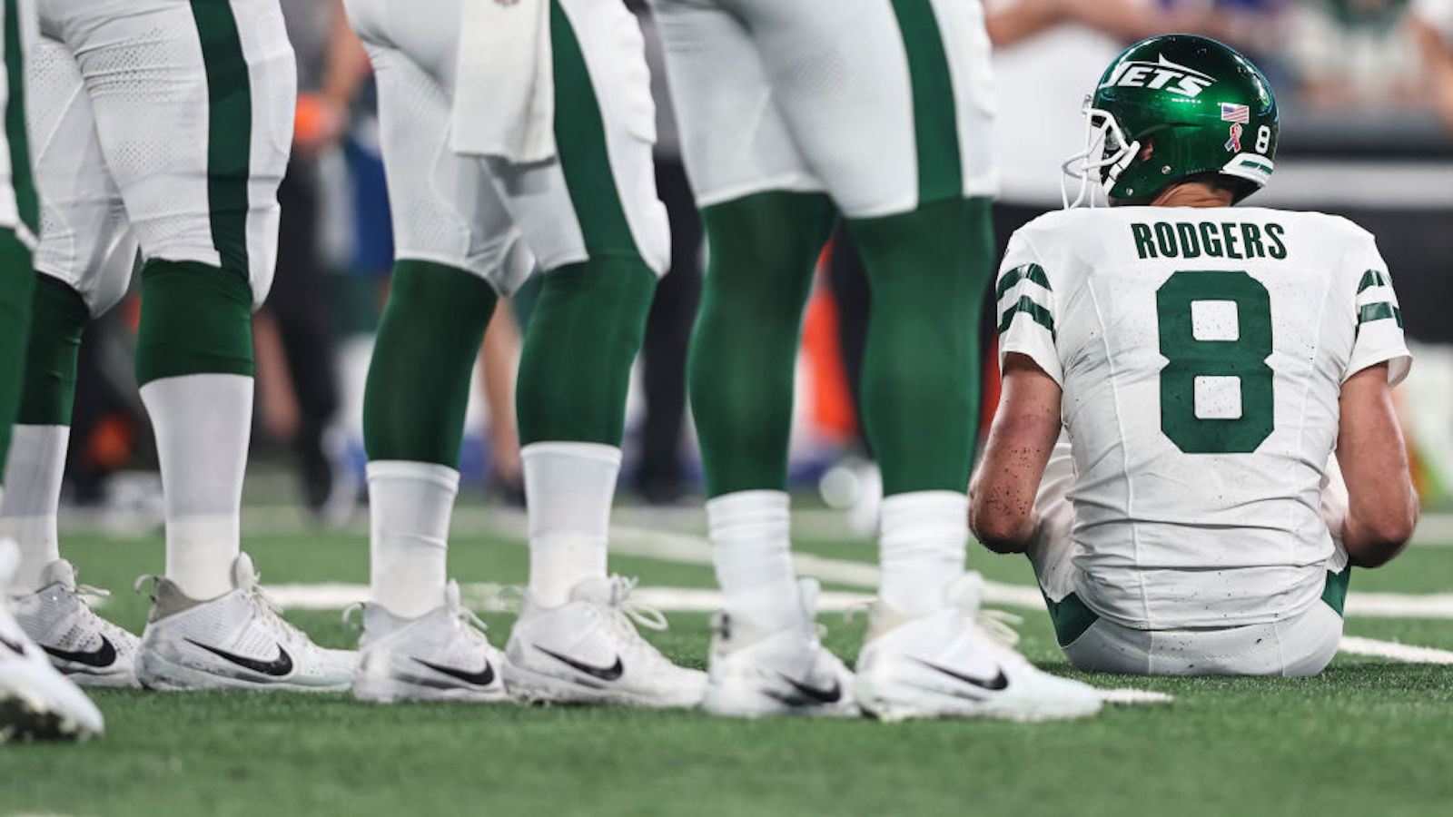 Aaron Rodgers sits on the turf during an NFL football game between the New York Jets and the Buffalo Bills, Monday, Sept. 11, 2023, in East Rutherford, N.J.