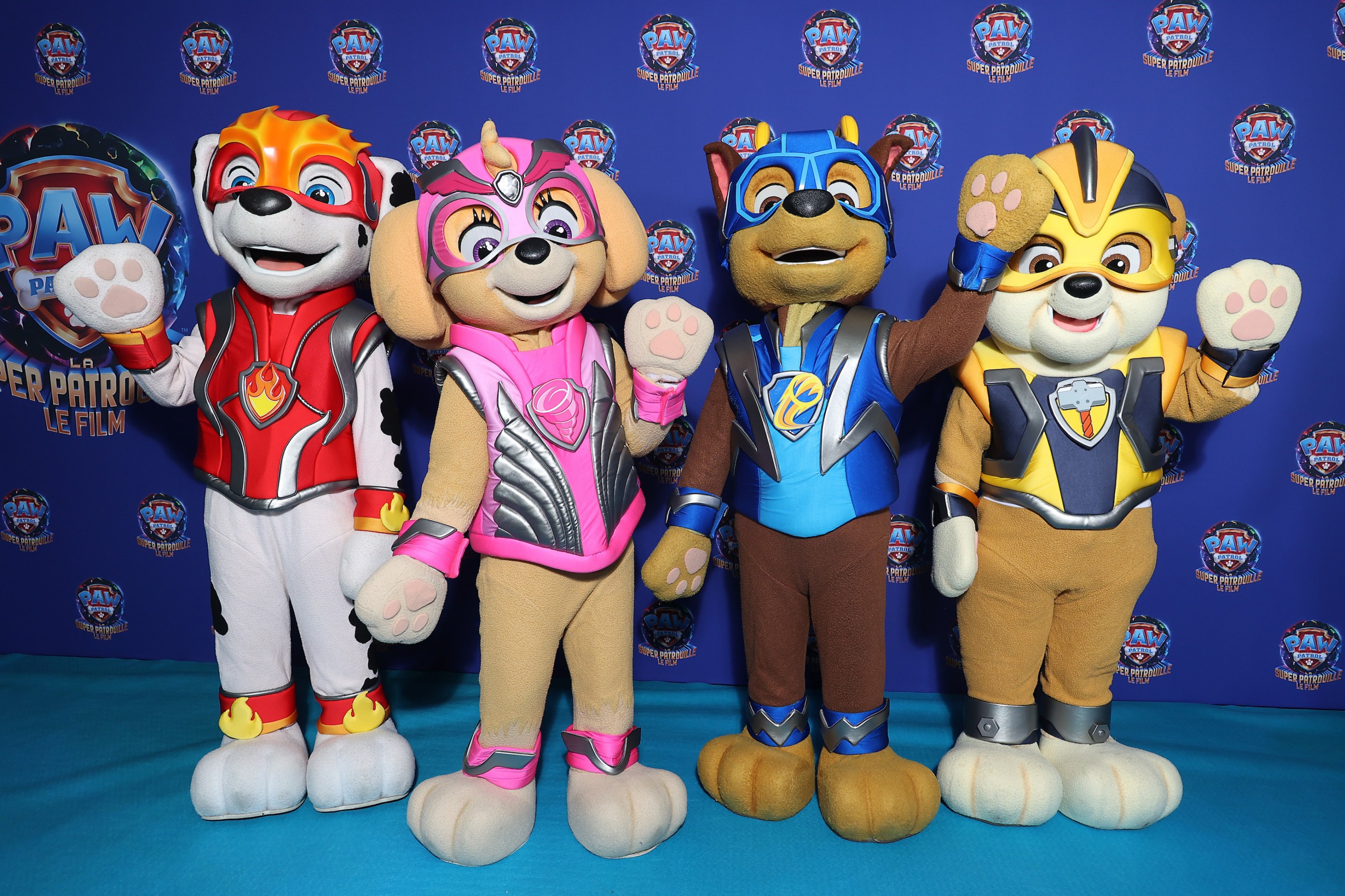 The animals from Paw Patrol, or more accurately people wearing costumes of the animals from Paw Patrol, waving at the Paris premiere of the Paw Patrol movie.