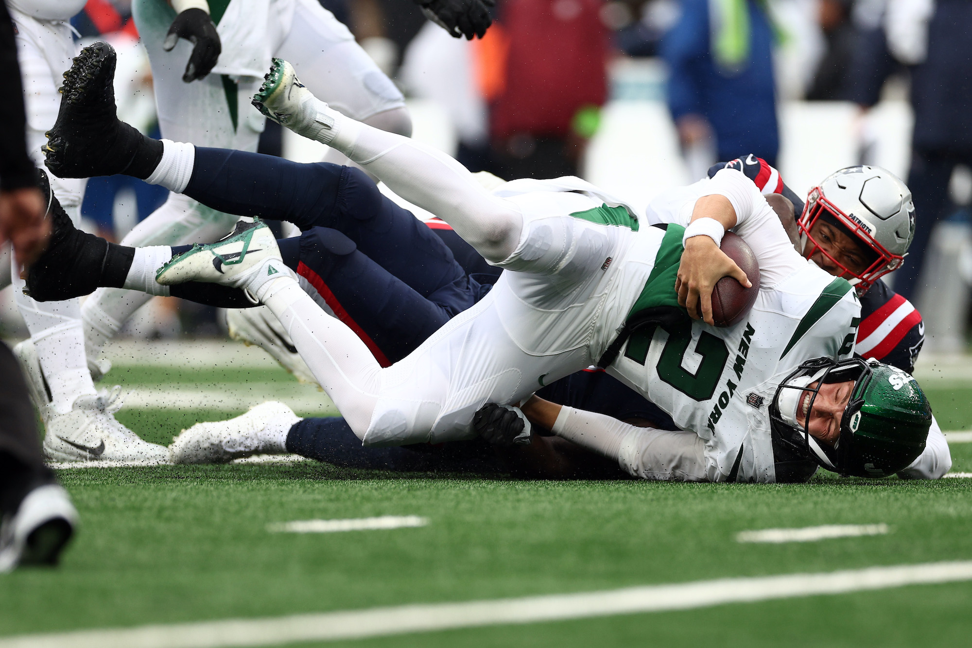 Zach Wilson is sacked during the Patriots-Jets game.