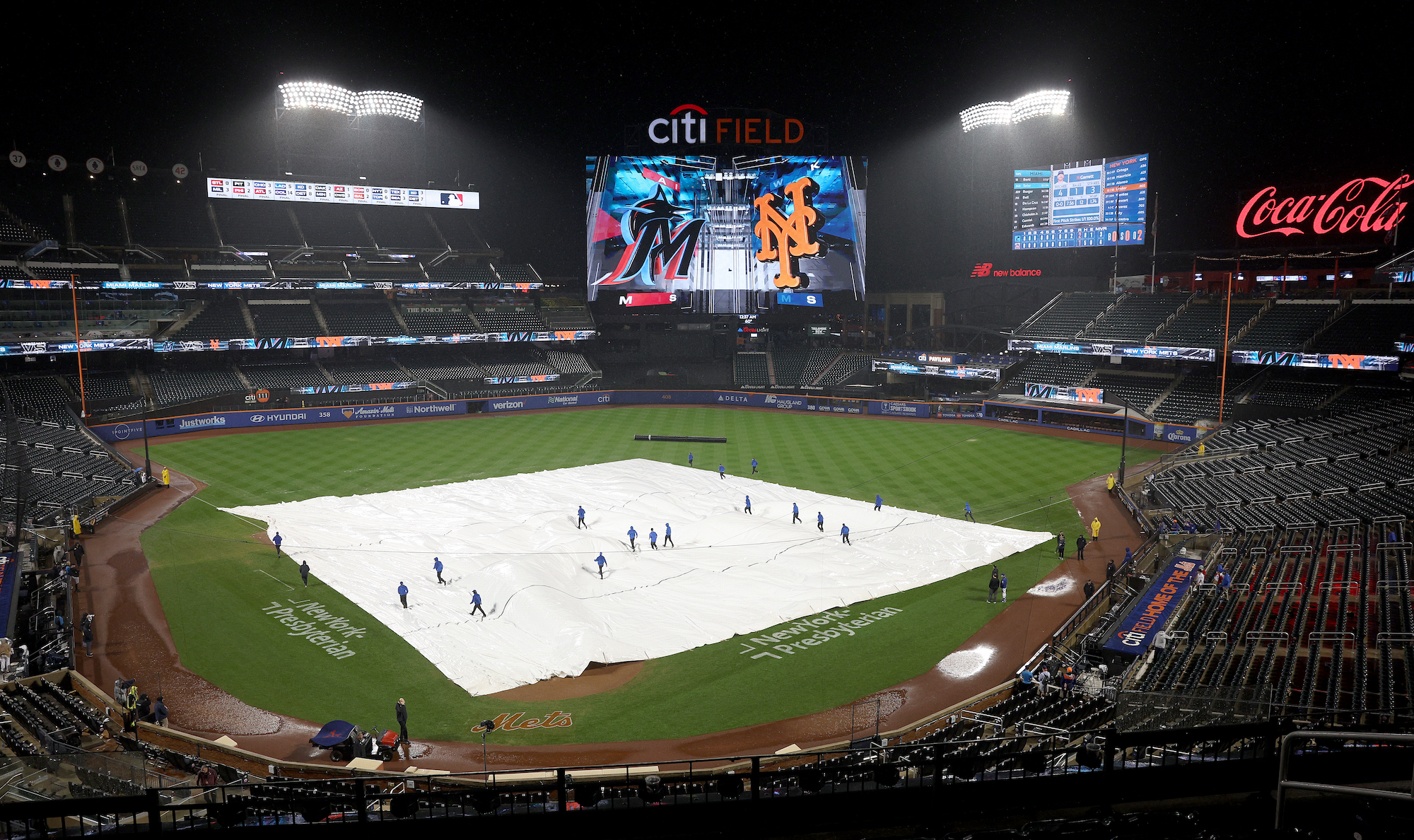 NEW YORK, NEW YORK - SEPTEMBER 28: The Grounds crew pull the tarp back on the field at Citi Field on September 28, 2023 in the Flushing neighborhood of the Queens borough of New York City. (Photo by Elsa/Getty Images)