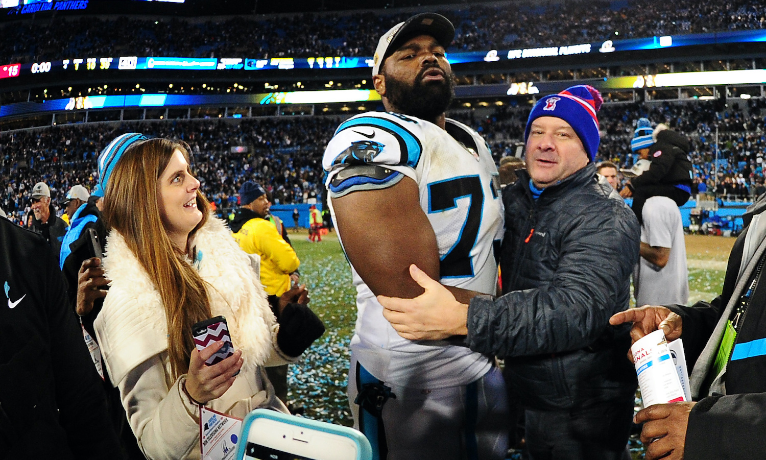 Michael Oher #73 of the Carolina Panthers celebrates with his family after the NFC Championship Game against the Arizona Cardinals at Bank Of America Stadium on January 24, 2016 in Charlotte, North Carolina.
