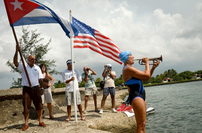 US swimmer Diana Nyad (C) plays a bugle preparing for her departure from the Ernest Hemingway Nautical Club in Havana on August 18, 2012 . Veteran US endurance swimmer Diana Nyad announced that she will try to swim the treacherous waters from Cuba to Florida without a shark cage.