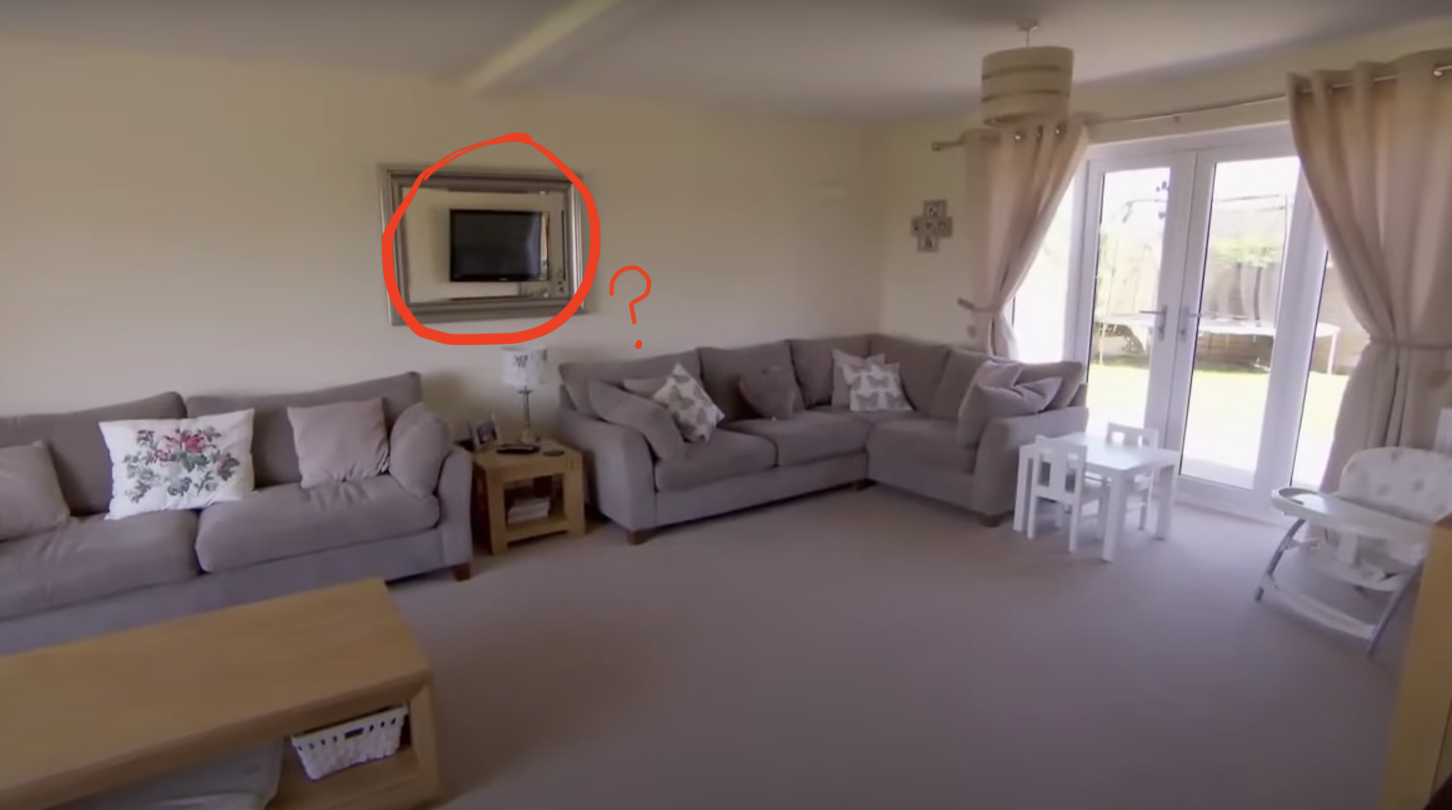A very weird TV, reflected in a wall-mounted mirror in a large British "sitting room."