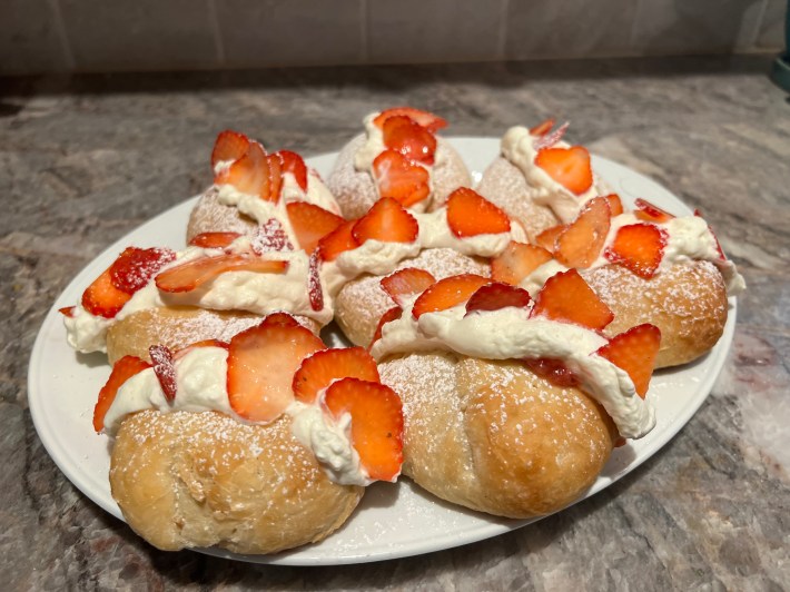 Eight finished Devonshire splits, scattered with strawberries and dusted with icing sugar. Actually they are fine!