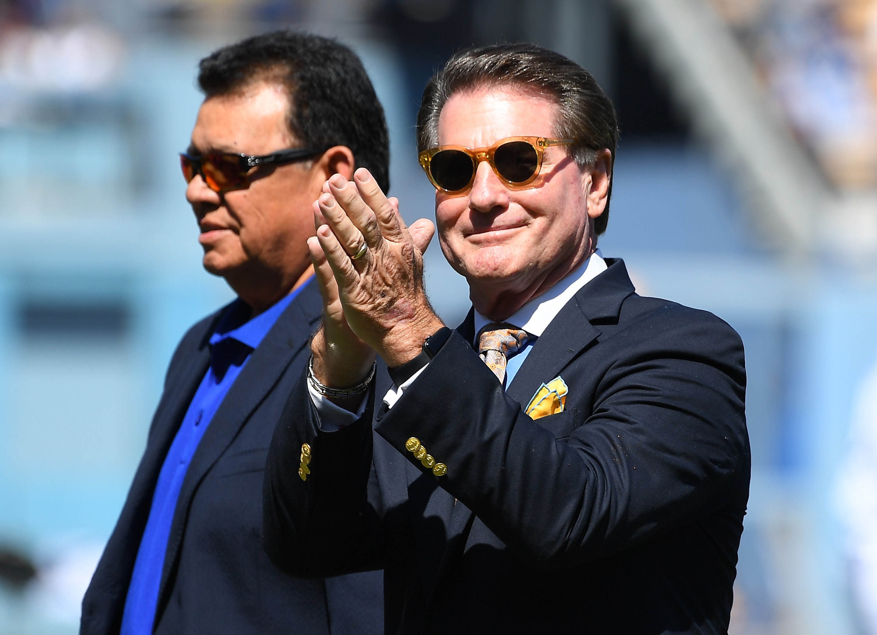 Steve Garvey, in the foreground, at his induction into the Legends of Dodgers Baseball inaugural class back in September of 2018. He's got sunglasses on and is clapping.