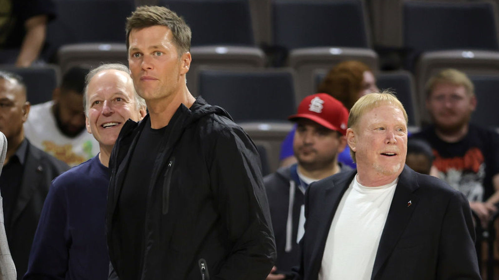 Sportscaster Jim Gray, Tampa Bay Buccaneers quarterback Tom Brady and Las Vegas Raiders owner and managing general partner and Las Vegas Aces owner Mark Davis watch players warm up during halftime of a game between the Connecticut Sun and the Aces