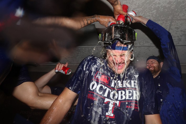 Josh Jung of the Rangers being drenched in champagne.