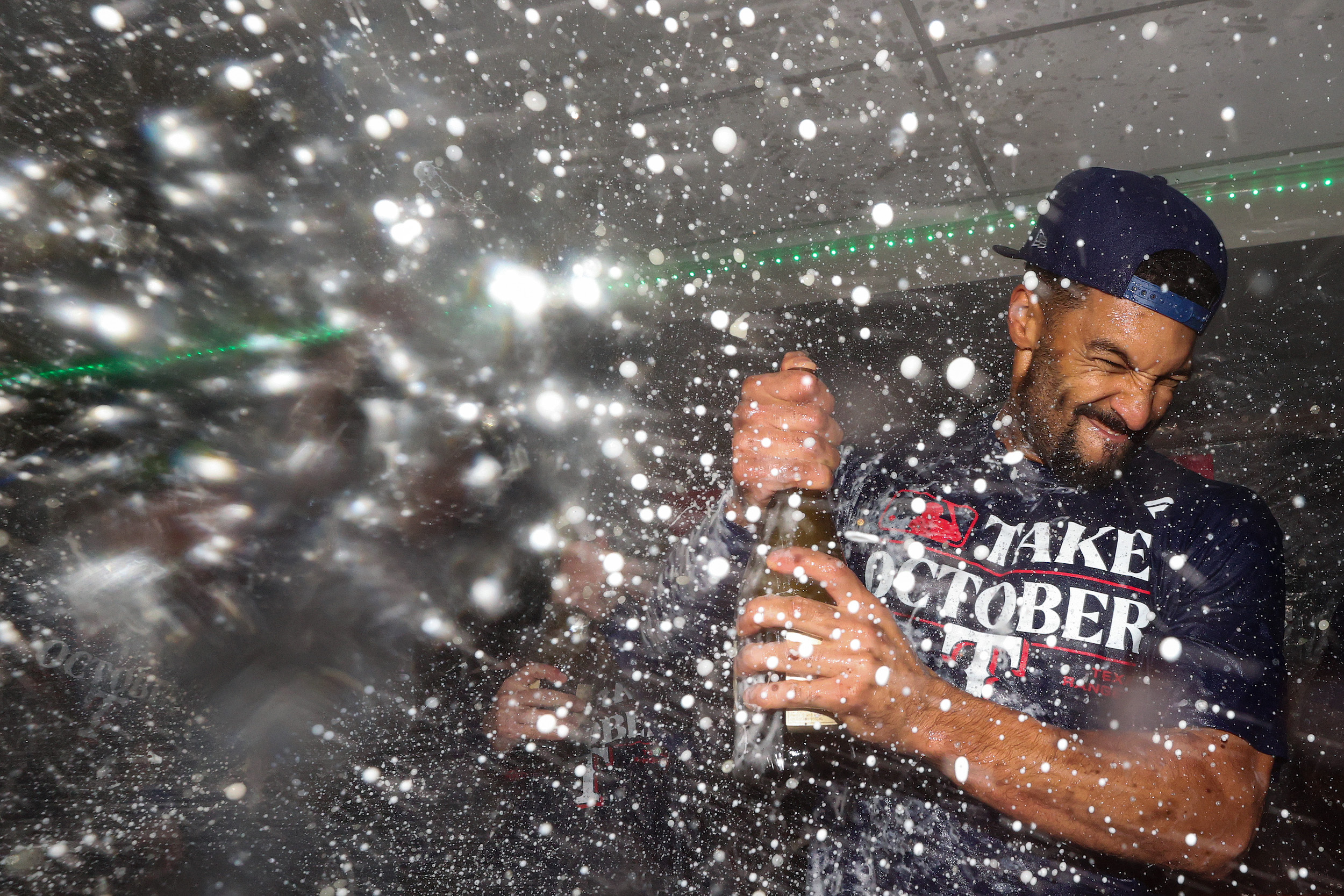 Marcus Semien of the Rangers pops champagne.