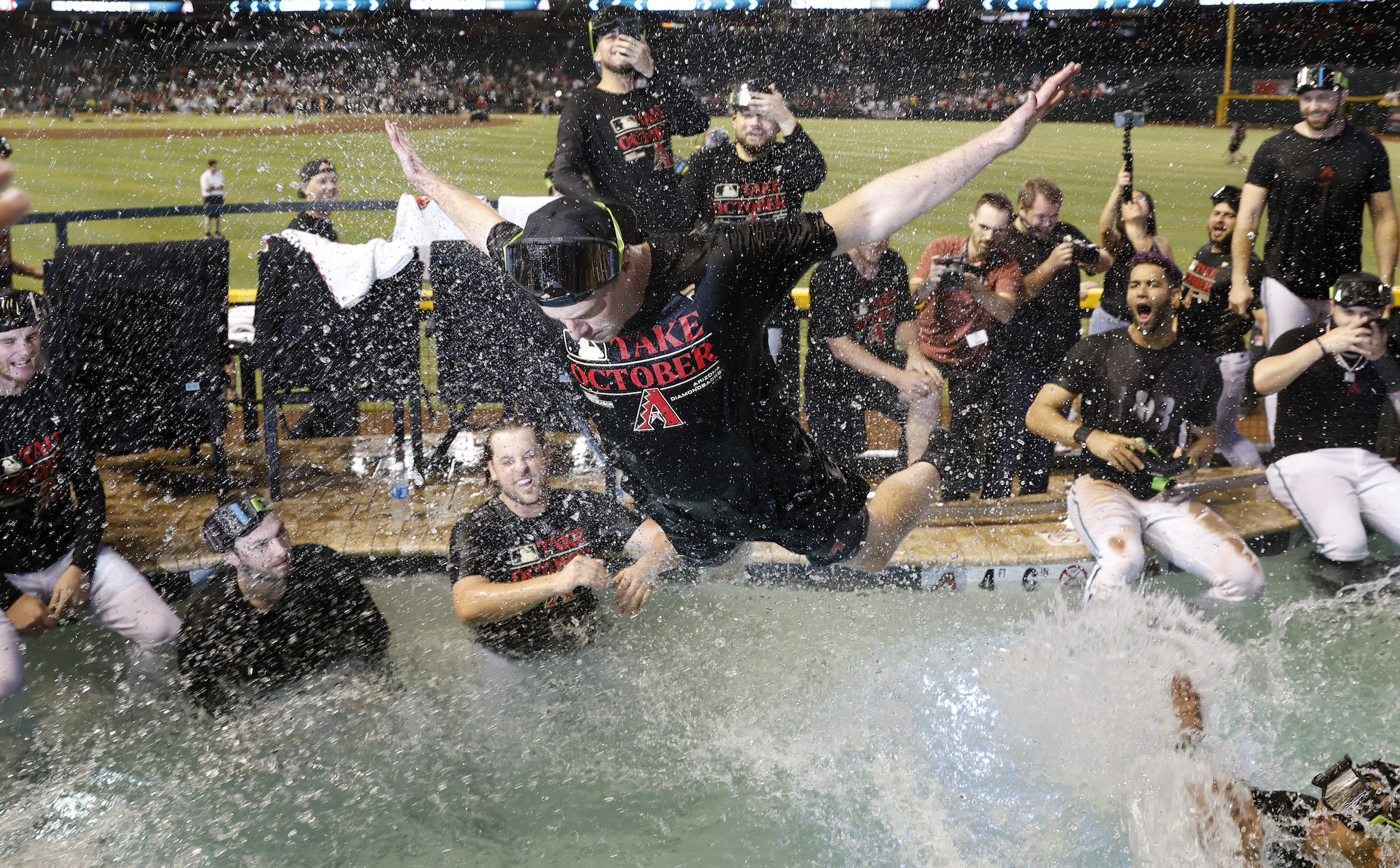 PHOENIX, ARIZONA - SEPTEMBER 30: Arizona Diamondbacks players celebrate in the Chase Field pool after clinching a National League Wild Card playoff spot after the game against the Houston Astros on September 30, 2023 in Phoenix, Arizona. (Photo by Chris Coduto/Getty Images)