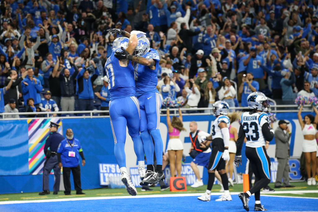 Sam LaPorta and Josh Reynolds celebrate after scoring a touchdown