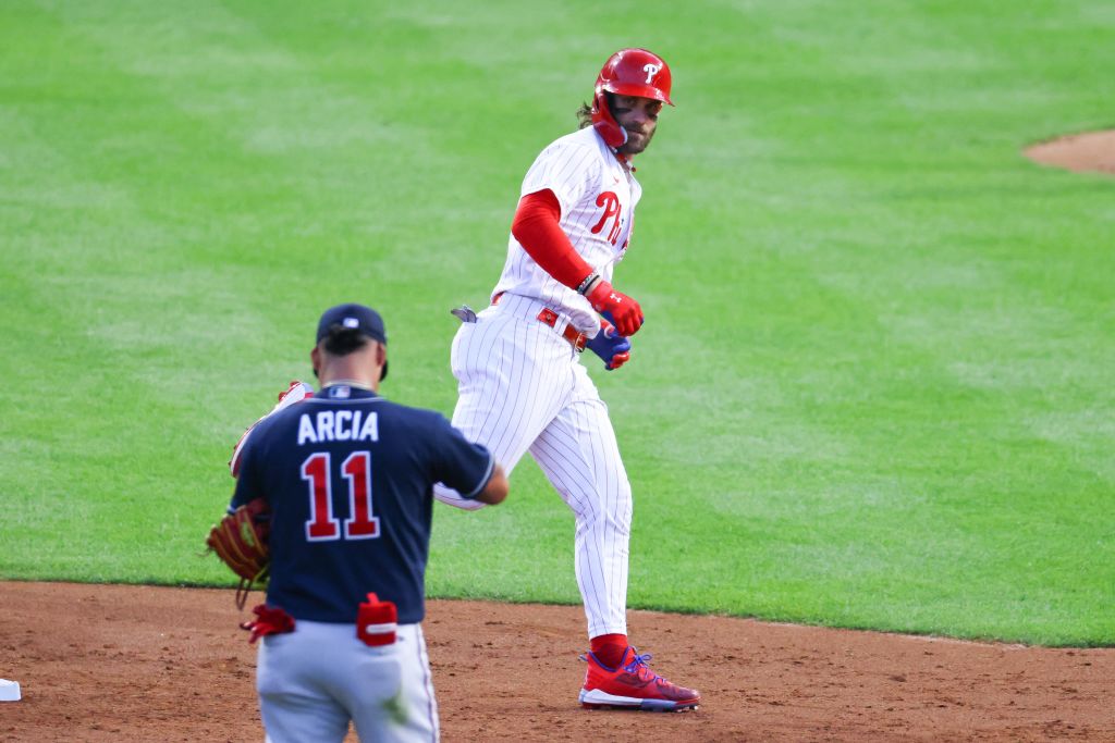 Bryce Harper #3 of the Philadelphia Phillies rounds second base ant stares down Orlando Arcia #11 of the Atlanta Braves during Game 3 of the NLDS on October 11, 2023 at Citizens Bank Park in Philadelphia, Pennsylvania.