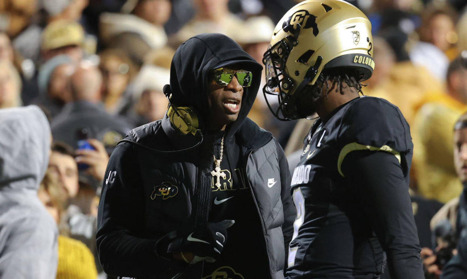 Head coach Deion Sanders and Shedeur Sanders #2 of the Colorado Buffaloes talk before taking on the Stanford Cardinal at Folsom Field on October 13, 2023 in Boulder, Colorado.