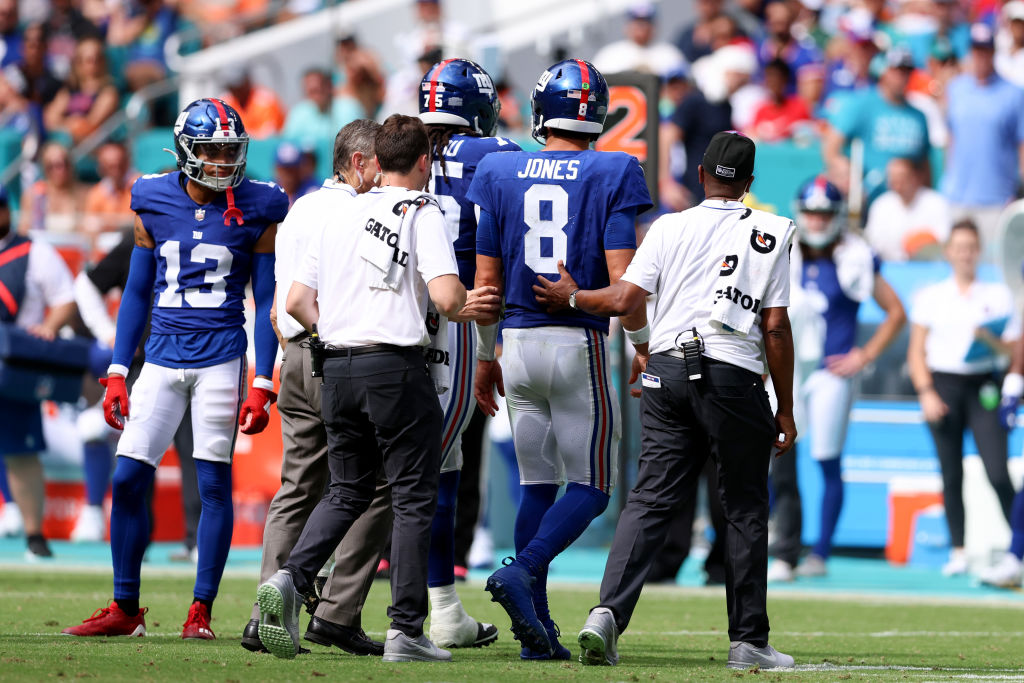 Quarterback Daniel Jones #8 of the New York Giants is helped off the field after an injury against the Miami Dolphins during the fourth quarter at Hard Rock Stadium on October 08, 2023 in Miami Gardens, Florida.