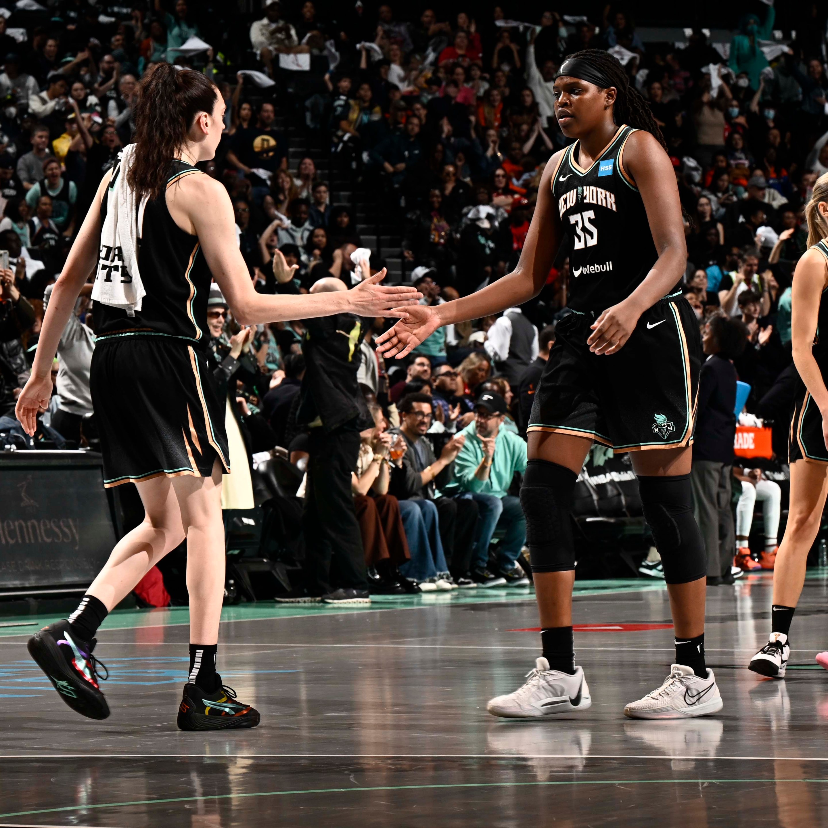 Jonquel Jones #35 of the New York Liberty and Breanna Stewart #30 high five during the game against the Las Vegas Aces during game 3 of the 2023 WNBA Finals on October 15, 2023 at the Barclays Center in Brooklyn, New York.