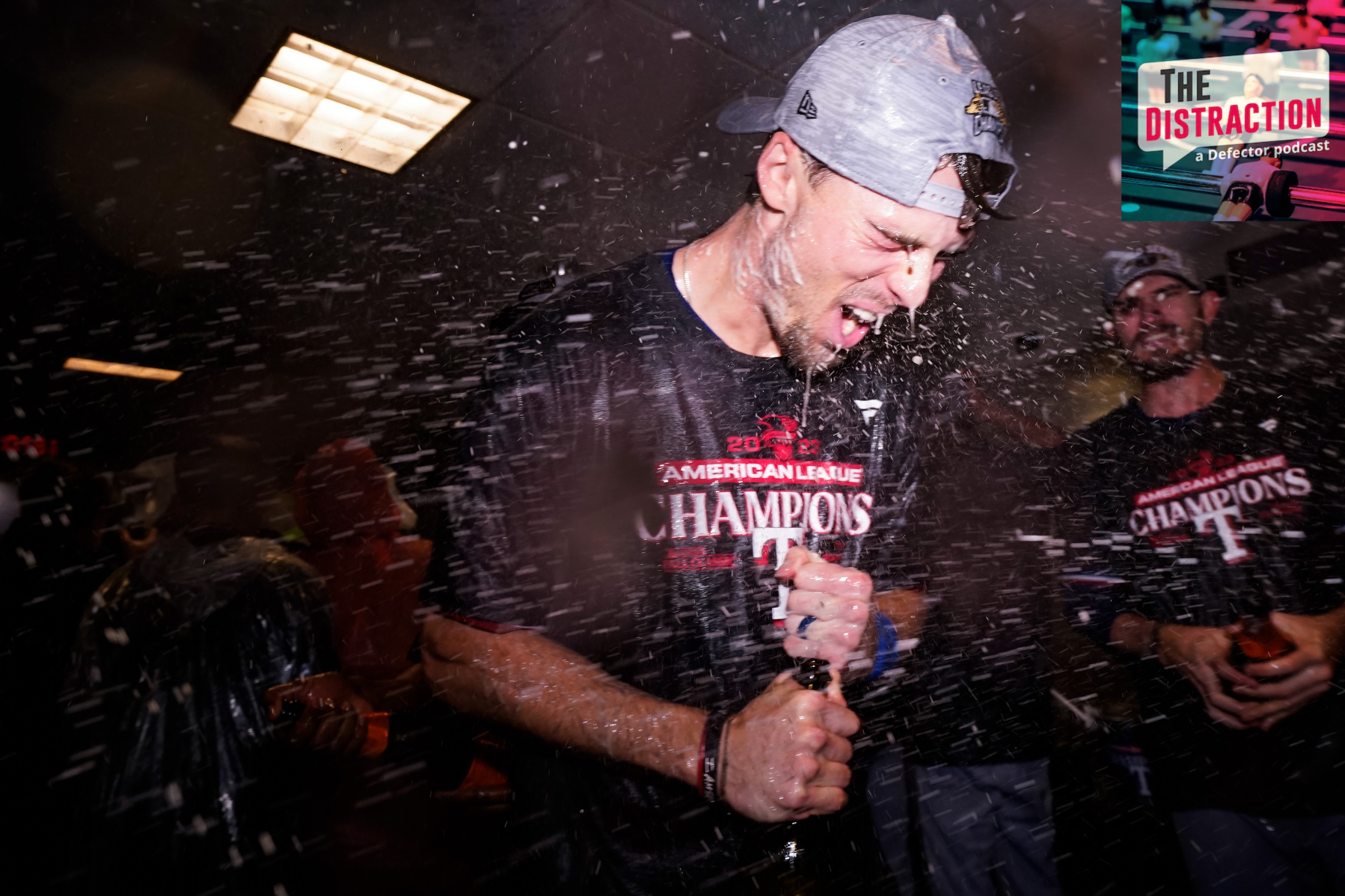 Evan Carter of the Texas Rangers celebrates in the clubhouse after beating the Astros in Game 7 of the ALCS.