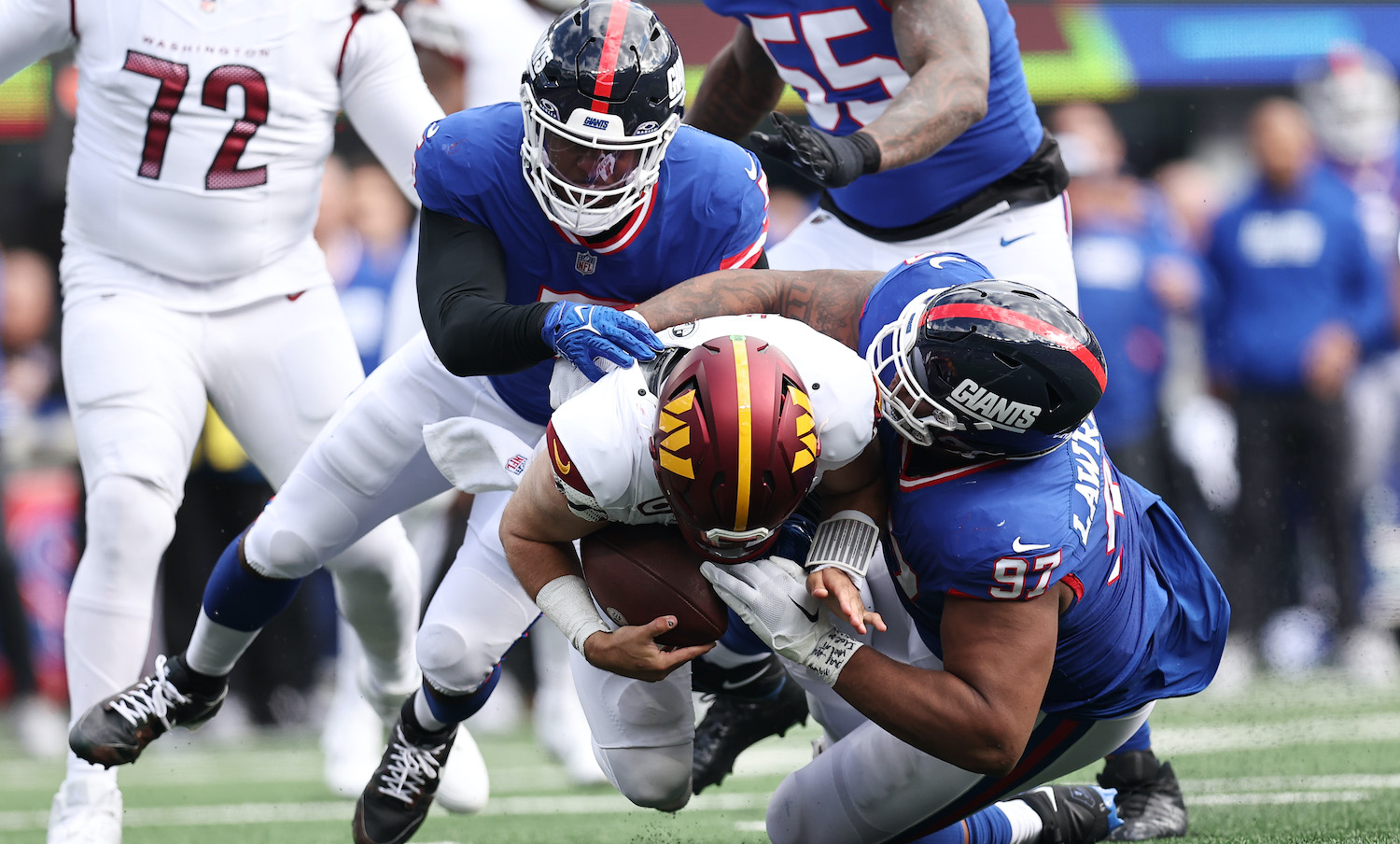 EAST RUTHERFORD, NEW JERSEY - OCTOBER 22: Dexter Lawrence II #97 and Kayvon Thibodeaux #5 of the New York Giants sack Sam Howell #14 of the Washington Commanders in the second quarter of the game at MetLife Stadium on October 22, 2023 in East Rutherford, New Jersey. (Photo by Dustin Satloff/Getty Images)