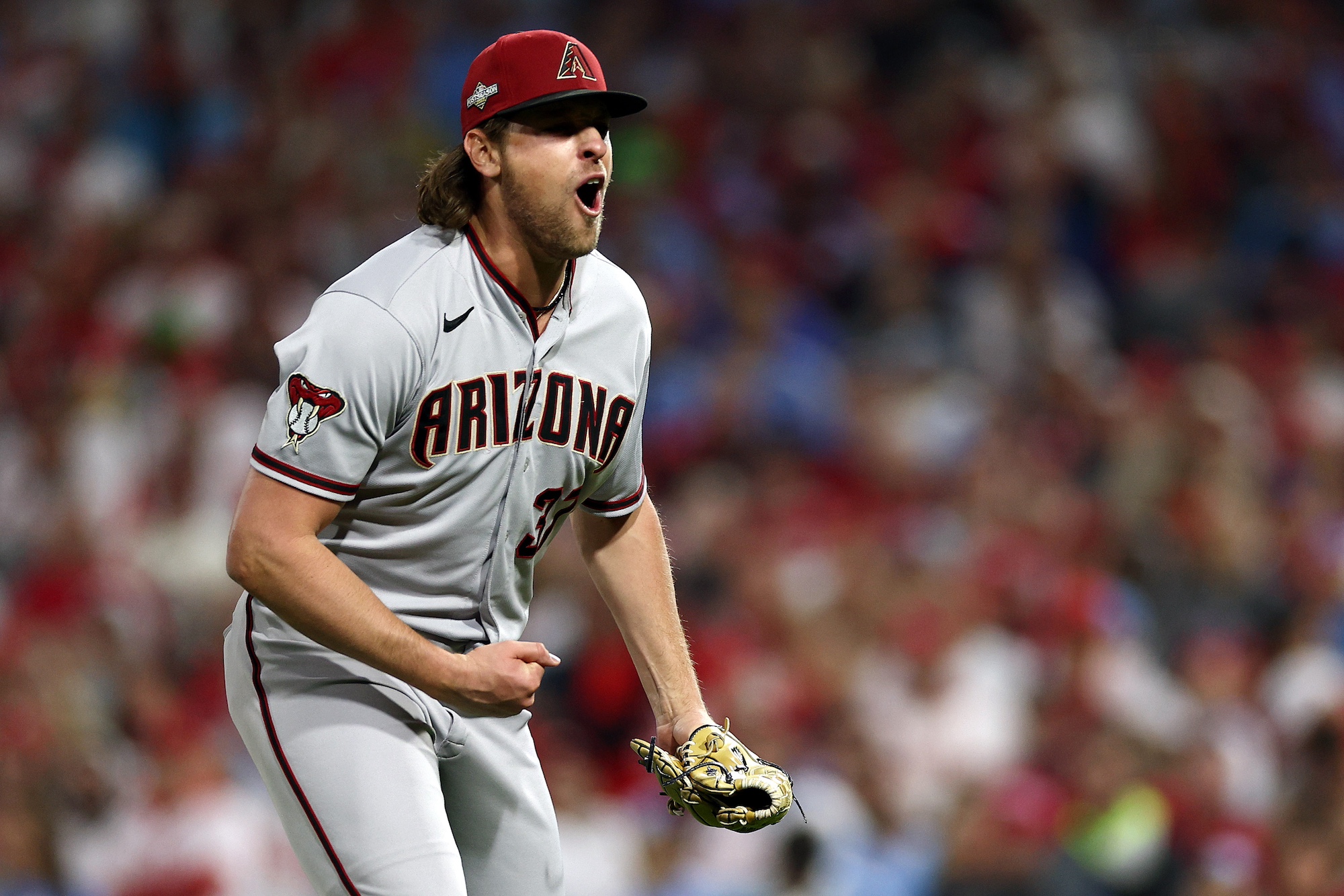 PHILADELPHIA, PENNSYLVANIA - OCTOBER 24: Kevin Ginkel #37 of the Arizona Diamondbacks reacts after striking out J.T. Realmuto #10 of the Philadelphia Phillies (not pictured) during the eighth inning in Game Seven of the Championship Series at Citizens Bank Park on October 24, 2023 in Philadelphia, Pennsylvania. (Photo by Elsa/Getty Images)