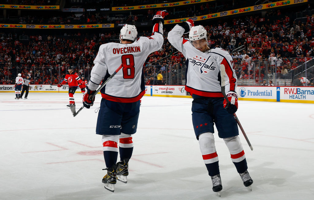 Alex Ovechkin celebrates his empty net goal with Dylan Strome