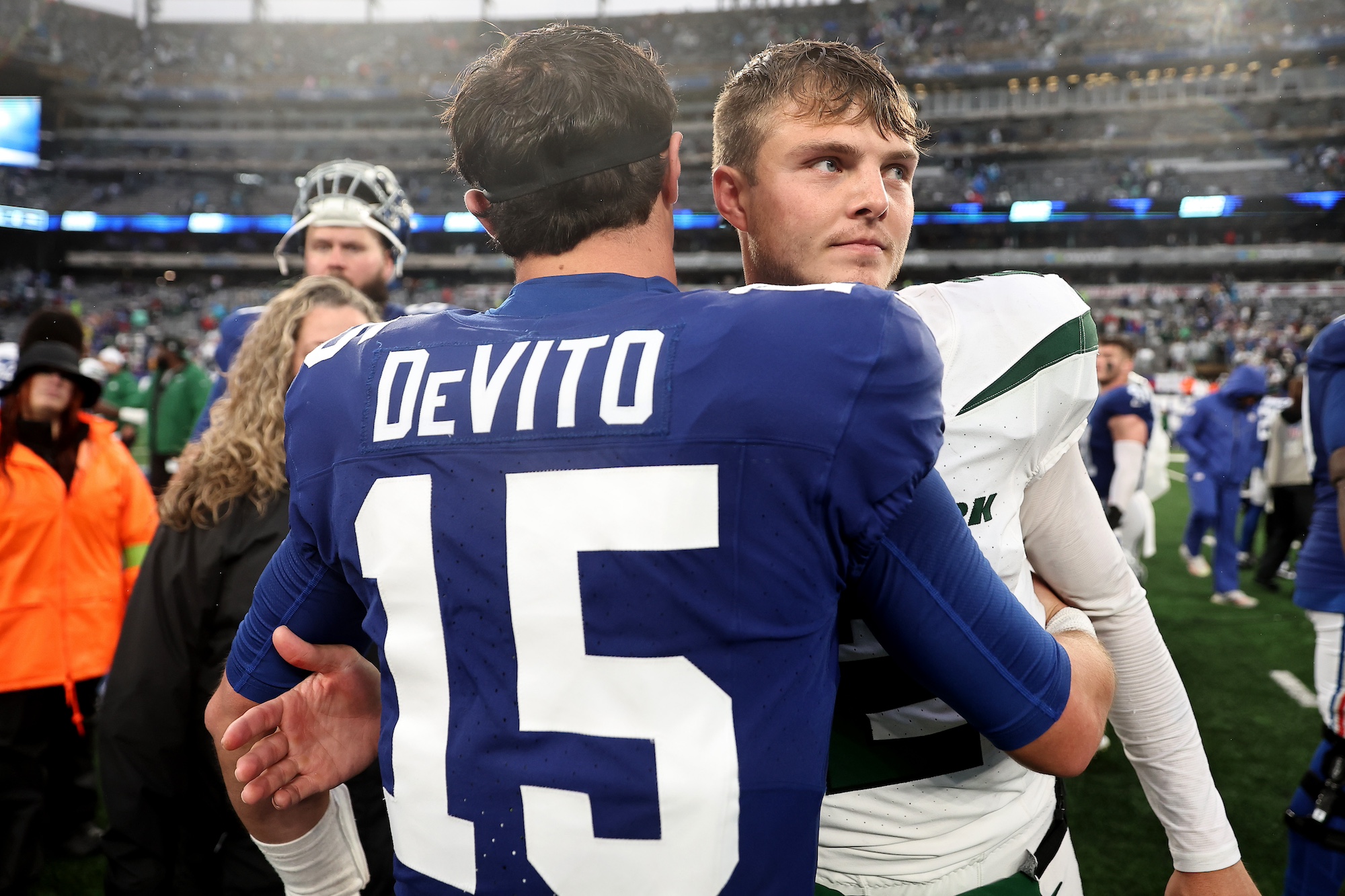 EAST RUTHERFORD, NEW JERSEY - OCTOBER 29: Tommy DeVito #15 of the New York Giants hugs Zach Wilson #2 of the New York Jets after the Jets' 13-10 overtime win at MetLife Stadium on October 29, 2023 in East Rutherford, New Jersey. (Photo by Dustin Satloff/Getty Images)