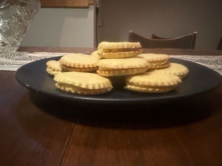 Kelsey's finished cookies, piled on a plate, shown from the side.